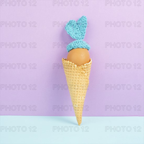 Cute easter bunny or rabbit with an egg face in an ice cream cone, spring holiday, greeting card