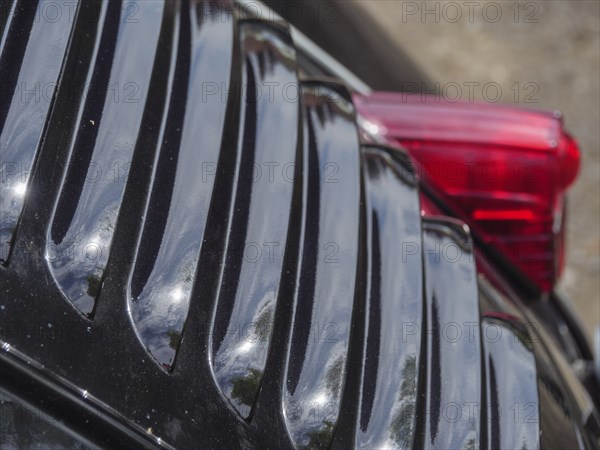 Close-up of a black vintage car, showing air vents and reflective surfaces, winterswijk,