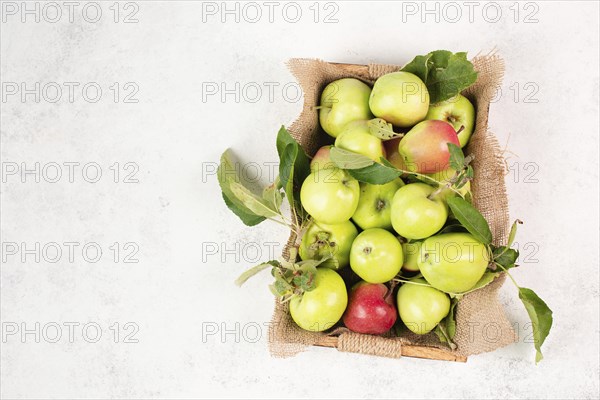 Apples in a basket standing on a table, fruit harvest in the summer, healthy organic food