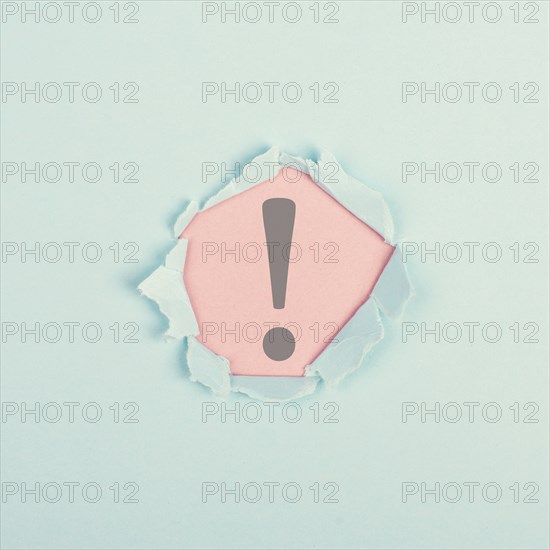 Exclamation mark surrounded by torn paper, alert sign, information and warning concept
