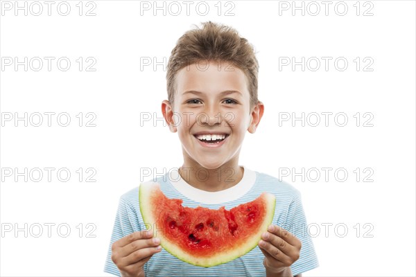 Handsome smiling child boy hand holding red ripe watermelon fruit food slice white isolated