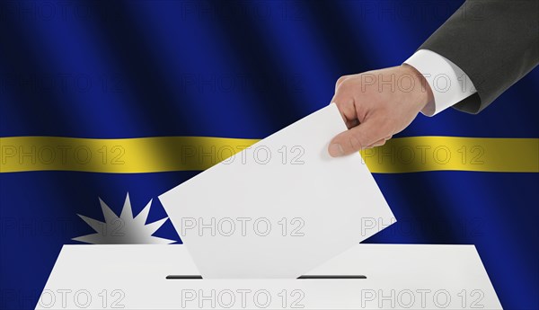 The Nauru flag and the hand with the bulletin about the ballot box