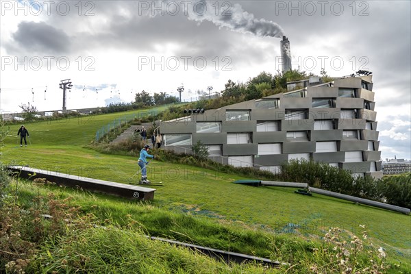 CopenHill, waste incineration plant and artificial ski slope, skiing with a view of the ski lift,