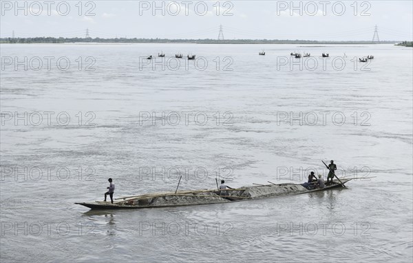 Labourer carries extracted sand from Beki River, in Barpeta district in Assam, India on Sunday