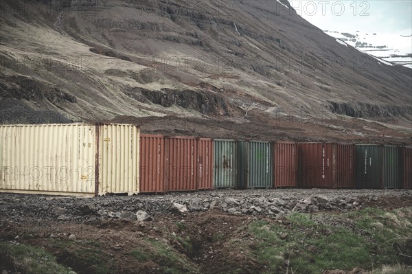Colorful export import cargo shipping container standing next to each other next to the road at