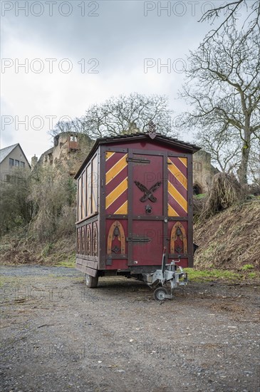 Decorative Trailer made of wood, Christmas market stand on a trailer in front of an old castle,