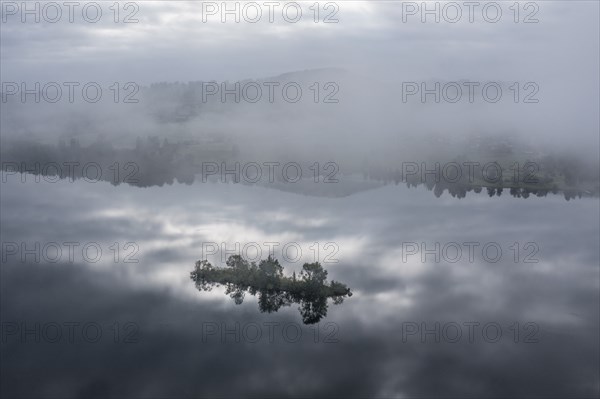 Aerial view over lake Rottachsee to village Petersthal, island in the lake, fog on the lake,