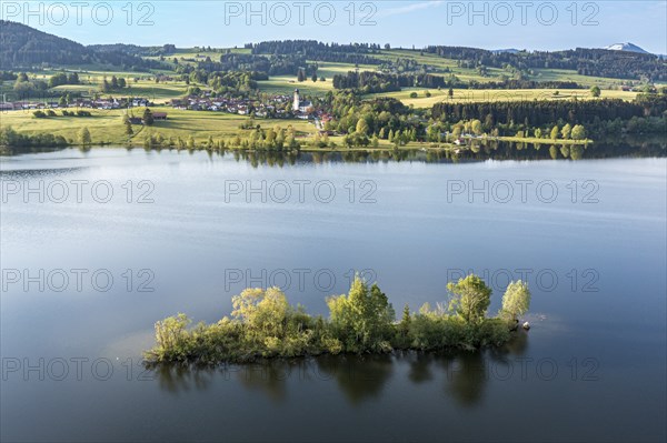 Aerial view over lake Rottachsee to village Petersthal, island in the lake, Allgäu, Bavaria,