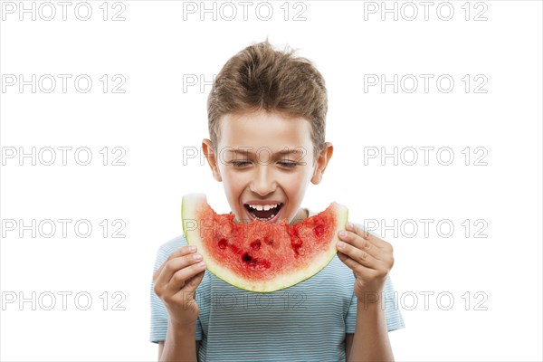 Handsome smiling child boy hand holding red ripe watermelon fruit food slice white isolated