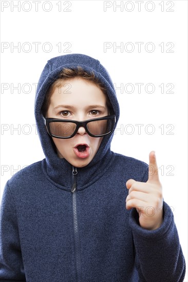 Amazed or surprised teenager boy wearing glasses gesturing exclamation point finger sign white