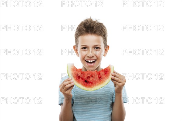 Handsome smiling child boy hand holding red ripe watermelon fruit food slice white isolated