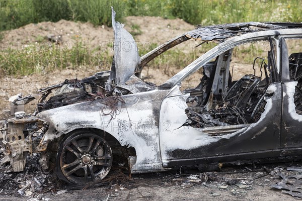 Road wreck accident or arson fire burnt wheel car vehicle junk