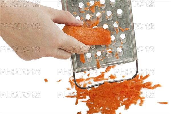 Hand holding carrot vegetable food kitchen grater
