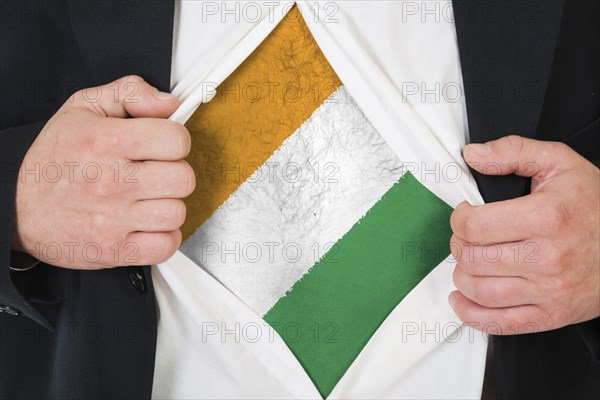 The Republic of Ivory Coast flag painted on the chest of a man
