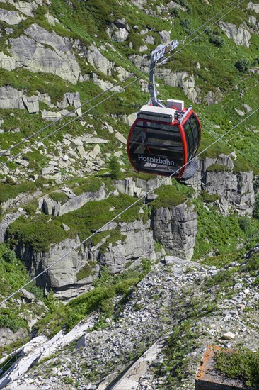 Cabin of cable car Hospizbahn travelling over mountainous alpine terrain to Grimsel Hospiz