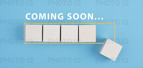 Coming soon is standing over a loading bar, hand puts the last cube, new arrival, promotion concept