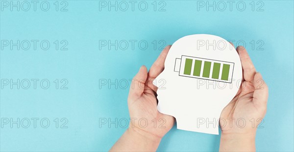 Head with a full loaded battery, positive thinking and mental health concept, brain with energy