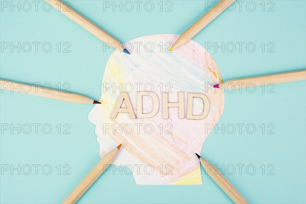 ADHD standing on a colorful head with pencils, attention deficit hyperactivity disorder, mental
