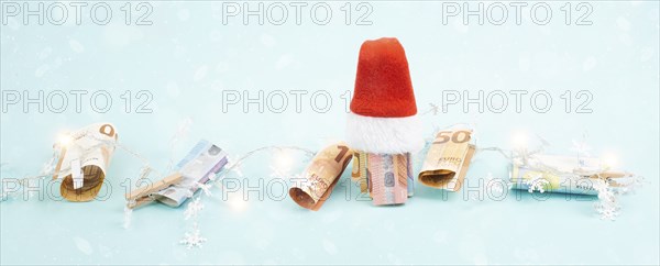 Christmas fairy lights with money, increase of electricity costs, save energy at the holiday season