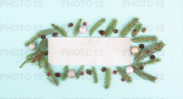 Christmas holiday background, frame with fir branches, baubles and cones, winter season greeting