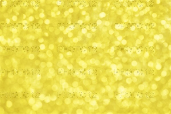Golden bokeh background for christmas, defocused round lights and sunbeams, flare overlay