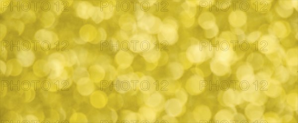 Golden bokeh background for christmas, defocused round lights and sunbeams, flare overlay