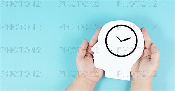 Silhouette of a head with a clock, time pressure and management in business, having a deadline or