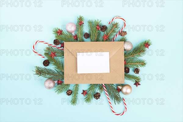 Christmas holiday background, frame with fir branches, baubles, candy cane and cones, winter season