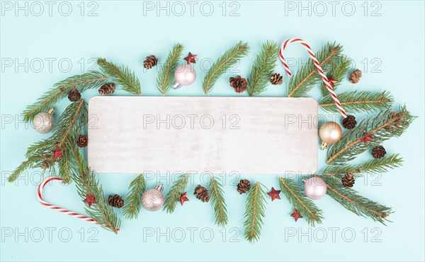 Christmas holiday background, frame with fir branches, baubles, candy cane and cones, winter season