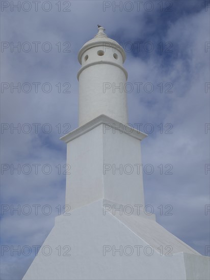 Lighthouse with a tower-shaped building under a cloudy sky in Lanzarote, arrecife, Lanzarote,