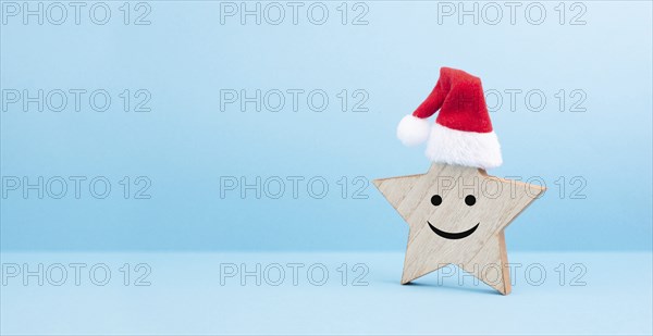 Star with a happy smiling face expression, red christmas hat, winter greeting card and banner, copy