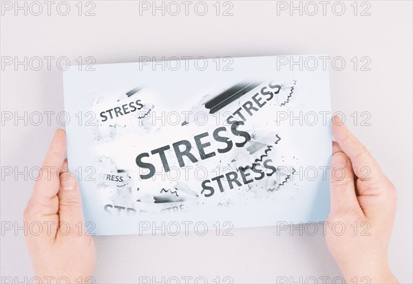 The word stress is standing on a paper, pen with eraser, burnout concept, work life balance,