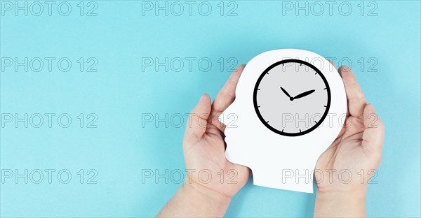 Silhouette of a head with a clock, time pressure and management in business, having a deadline or