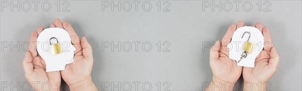 Silhouette of two people, one man is closed minded with a lock in his head, opposite to the person