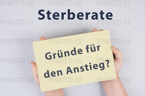 The german words for mortality rate, reasons for the increase are standing on the paper, covid-19