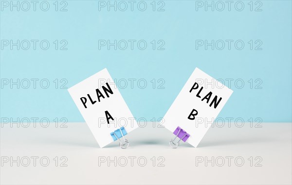 Plan A and B standing on paper, brainstorming for possibilities, making a decision