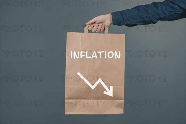 Inflation and financial crash, man holding empty shopping bag, economic development and increasing