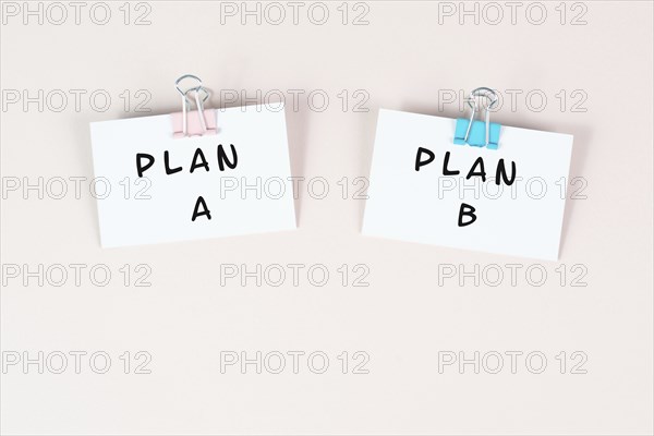 Plan A and B standing on paper, brainstorming for possibilities, making a decision