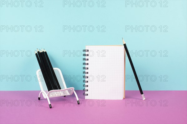 Empty notebook with pencils in a chair, being creative and brainstorming for new ideas, writing a