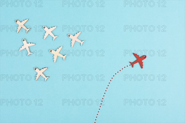 Airplanes following the group, red plane thinks different and takes the opposite direction,