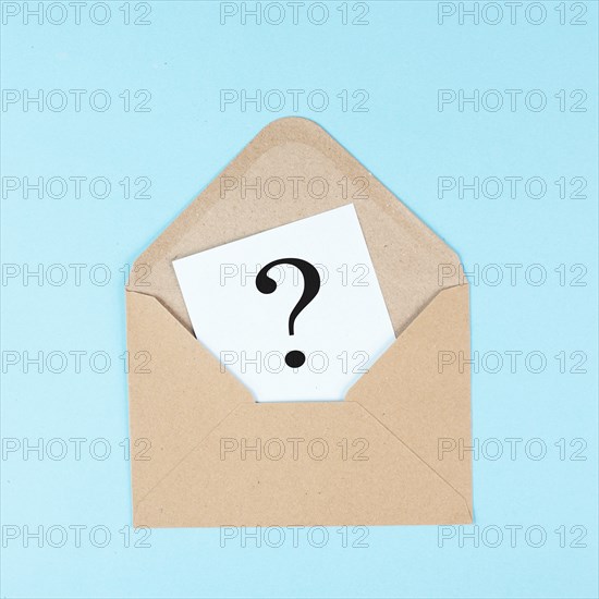 Question mark on a paper in an envelope, education and business concept, searching for answers,