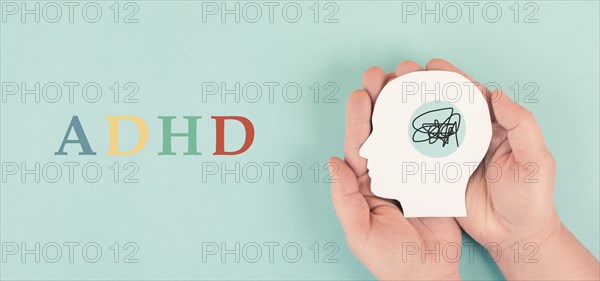 Hands holding a silhouette of a human head, attention deficit hyperactivity disorder, ADHD symptom,