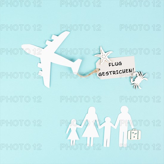 The words flight canceled are standing in german language on the sign of the airplane, staff