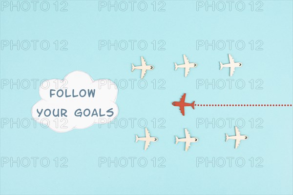 Red airplane is following his goal, leadership, courage and winner concept, standing out from the