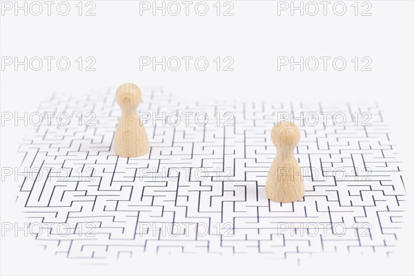 Men stand in the middle of a labyrinth, searching for a solution to exit, finding a strategy,