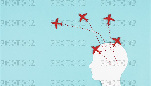 Silhouette of a head with red airplanes flying in different directions, having a vision for the