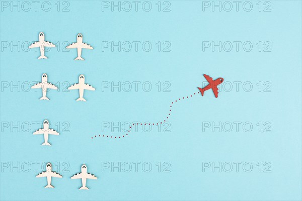 Airplanes following the group, red plane thinks different and takes the opposite direction,