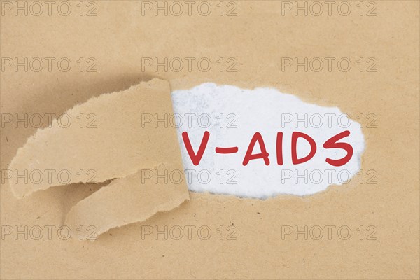 The words v-aids is standing in german language on on torn paper, vaccine damage, new autoimmune