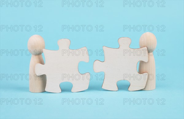 Two men with puzzle pieces built a team, connect the parts together, corporate in teamwork,