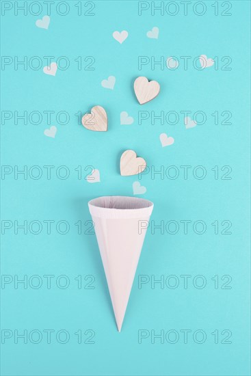 Cone with rose colored hearts, blue background, birthday and valentines day greeting card,